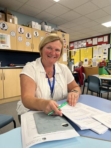 Sue Palmer sat at a desk in a classroom